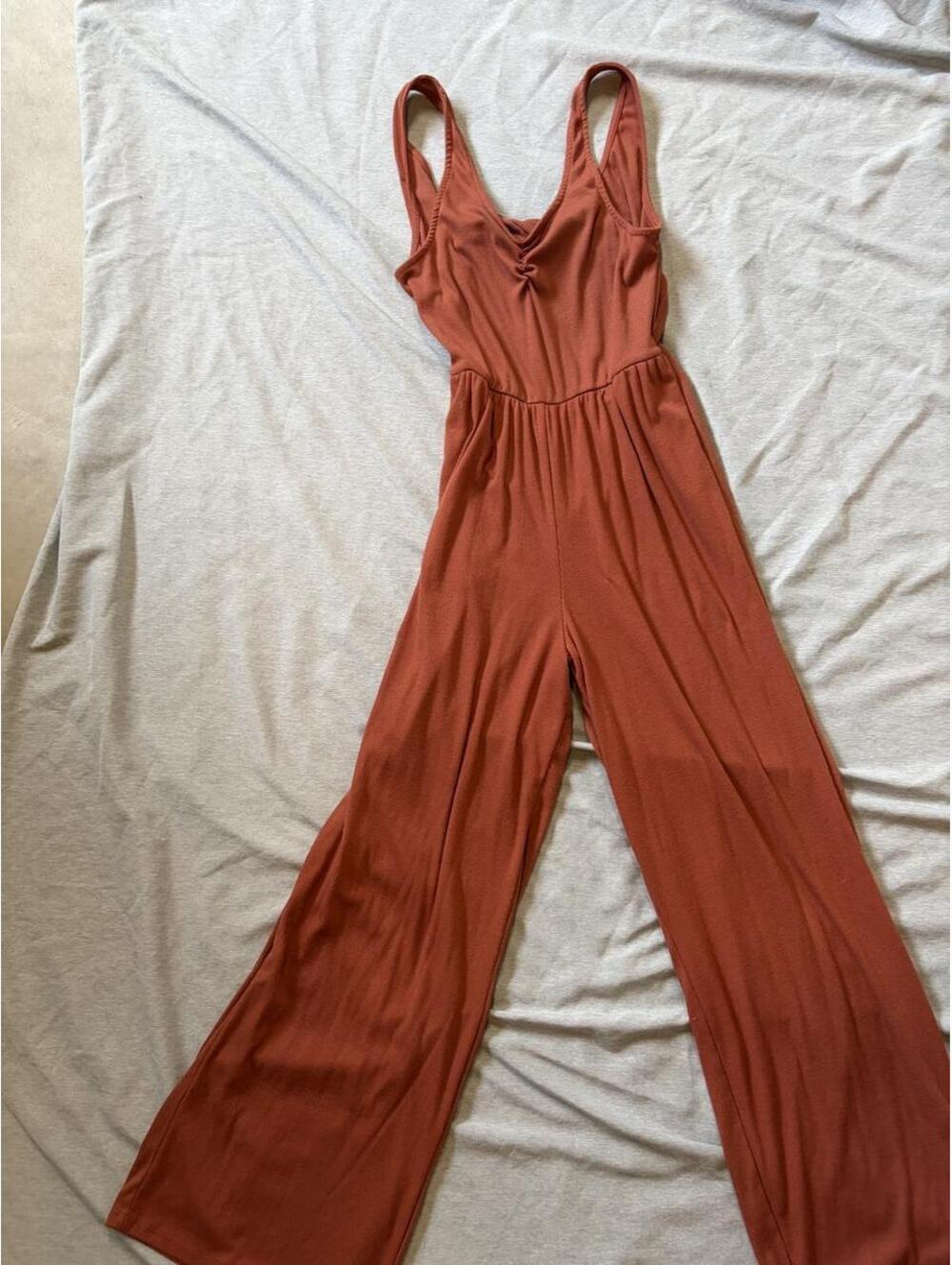 Cute and flattering ribbed jumpsuit in a warm rust/terracotta color.